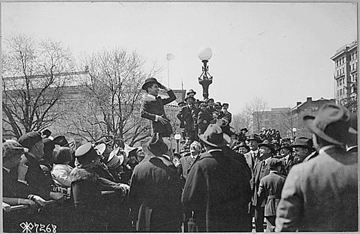 -Charlie Chaplin, comedy star of the "movies," making his first speech for the third Liberty Loan in front of the State, War and Navy Building, Washington, D.C., on first anniversary of U.S. entry into war