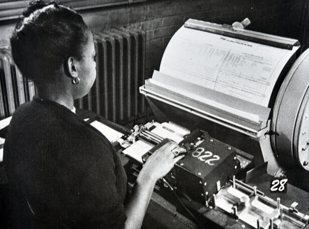 Census bureau employee typing and entering data onto punch cards from the handwritten forms typist