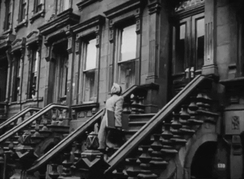 Animated black and white gif of a census enumerator walking up a set of brownstone stairs