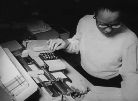 Animated gif of a woman typing with her left hand while reading a record