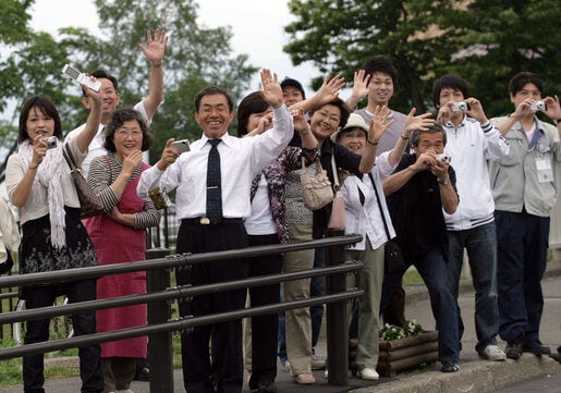 Crowds Wave at Mrs. Laura Bush's Motorcade in Hokkaido, Japan